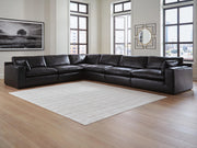Ashley Furniture Emilia sectional sofa in a neutral fabric with chaise lounge and plush cushions