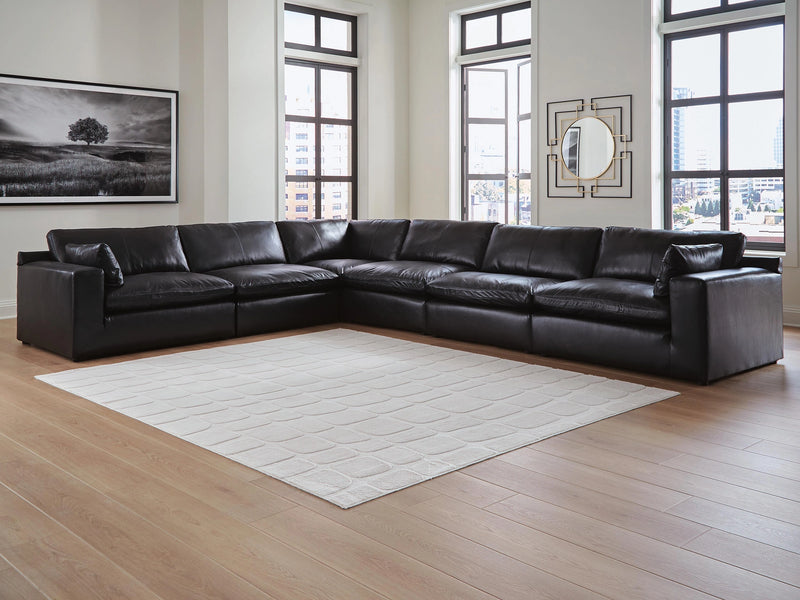 Ashley Furniture Emilia sectional sofa in a neutral fabric with chaise lounge and plush cushions