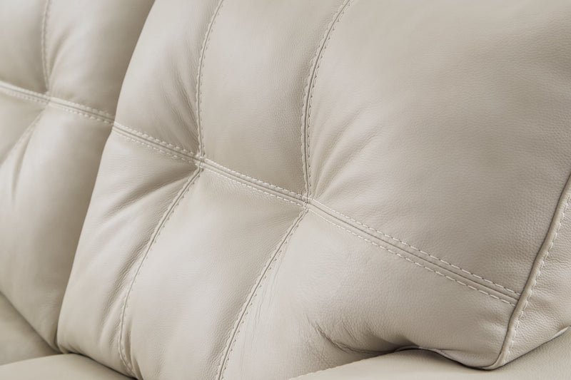 Ashley Furniture Santorine living room set, including sofa and loveseat with tufted upholstery, in a contemporary living room setting.
