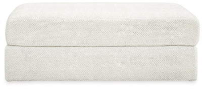 Ashley Furniture Karinne oversized accent ottoman in neutral fabric with a plush, tufted top and wooden block legs.