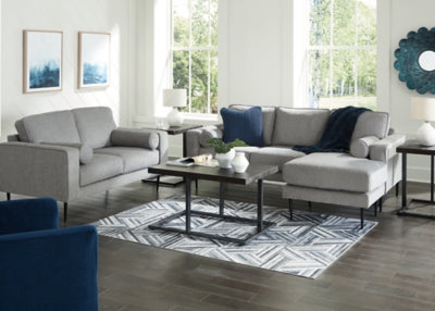 Ashley Furniture Hazela living room set with plush cushions, neutral fabric, and coordinated sofa and loveseat arrangement.