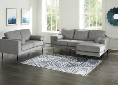 Ashley Furniture Hazela living room set with sofa, loveseat, and armchair arranged in a modern living space.