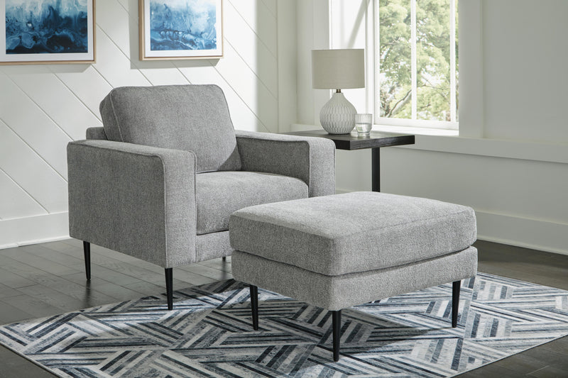 Ashley Furniture Hazela living room set featuring a sofa and loveseat with neutral upholstery and wooden legs.