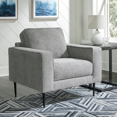Ashley Furniture Hazela living room set with sofa and armchair in a modern design, featuring neutral upholstery and wooden legs.