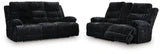 Ashley Furniture Rhine Falls living room set featuring power reclining sofa and loveseat with drop-down table, in a modern design.