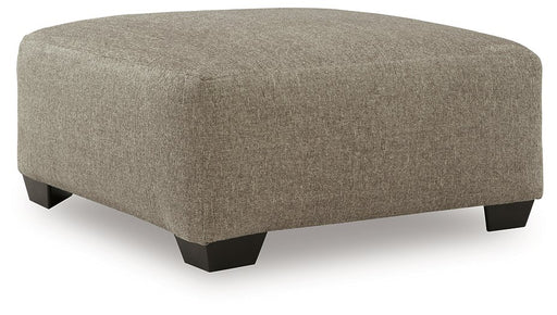 Ashley Furniture Newellen oversized accent ottoman with soft fabric upholstery and modern design, shown from an angled view.