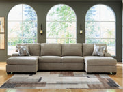 Ashley Furniture Newellen sectional with double chaise, showcasing plush cushions and modern design in a spacious living room setting.