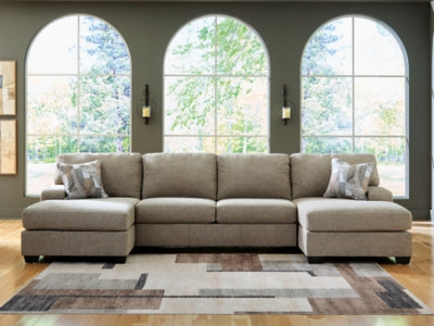 Ashley Furniture Newellen sectional with double chaise, showcasing plush cushions and modern design in a spacious living room setting.