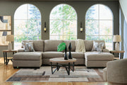 Ashley Furniture Newellen sectional with chaise, featuring plush cushions and neutral upholstery in a modern living room setting.
