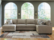 Ashley Furniture Newellen sleeper sectional with chaise, featuring plush cushions and a modern design in a cozy living room setting.