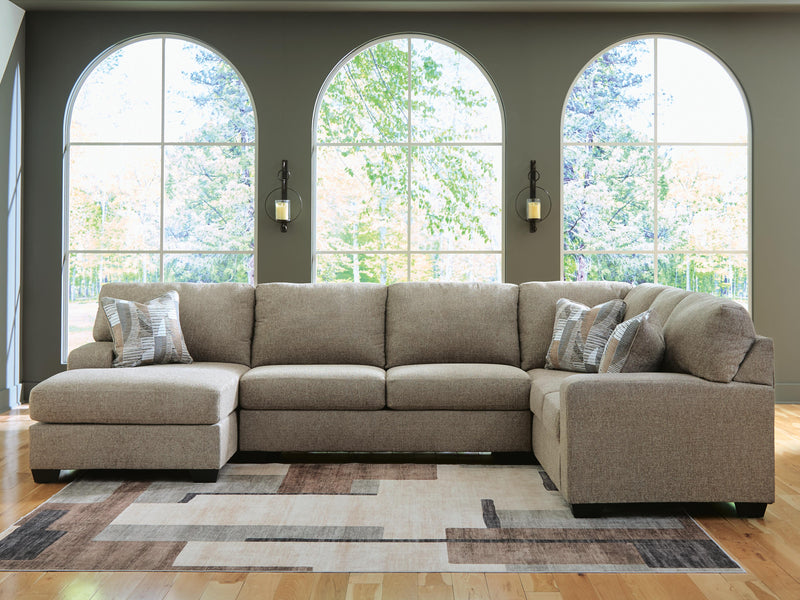 Ashley Furniture Newellen sectional with chaise showing plush fabric upholstery and modern design in a well-lit living room setting.