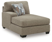 Ashley Furniture Newellen sectional with double chaise, showing a modern L-shaped sofa with plush cushions and stylish fabric upholstery.