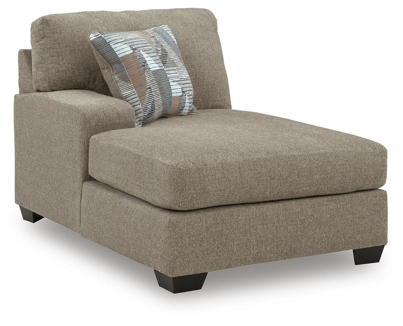 Ashley Furniture Newellen sectional with chaise, showing a modern fabric sofa with multiple cushions and a spacious chaise lounge.