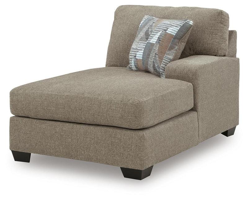 Ashley Furniture Newellen sectional with chaise, showing a modern fabric sofa with a spacious chaise lounge from an angled view.