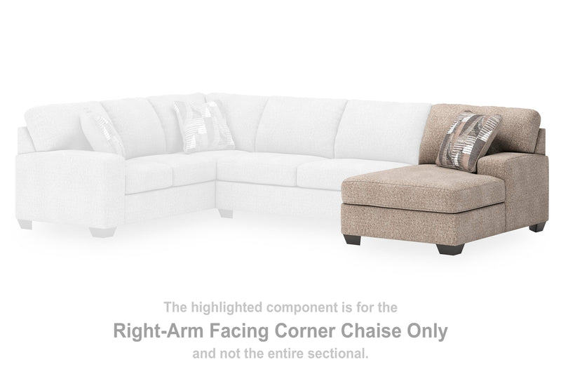 Ashley Furniture Newellen sectional with chaise, tan fabric sofa featuring plush cushions and a modern design in a living room setting.