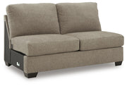 Ashley Furniture Newellen sectional with chaise, showing a modern L-shaped sofa with plush cushions and contemporary design.