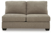 Ashley Furniture Newellen sleeper sectional with chaise, featuring plush cushions and a modern design, shown head-on from the front.