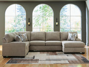 Ashley Furniture Newellen sleeper sectional with chaise, showing plush upholstery and modern design in a cozy living room setting.