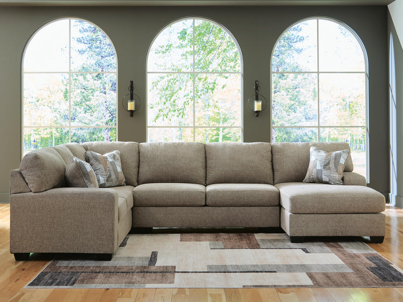 Ashley Furniture Newellen sectional with chaise, showing plush fabric upholstery and modern design in a living room setting.