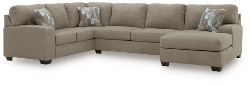 Ashley Furniture Newellen sleeper sectional with chaise showing plush fabric, spacious seating, and chaise lounge in a modern living room setting.