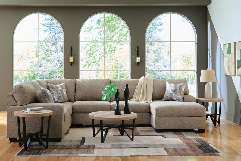 Ashley Furniture Newellen sectional with chaise in neutral upholstery, featuring plush cushions and modern design.
