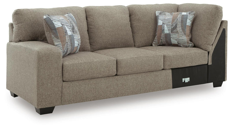 Ashley Furniture Newellen sleeper sectional with chaise, showing a modern fabric sofa with a chaise lounge and sleeping feature.