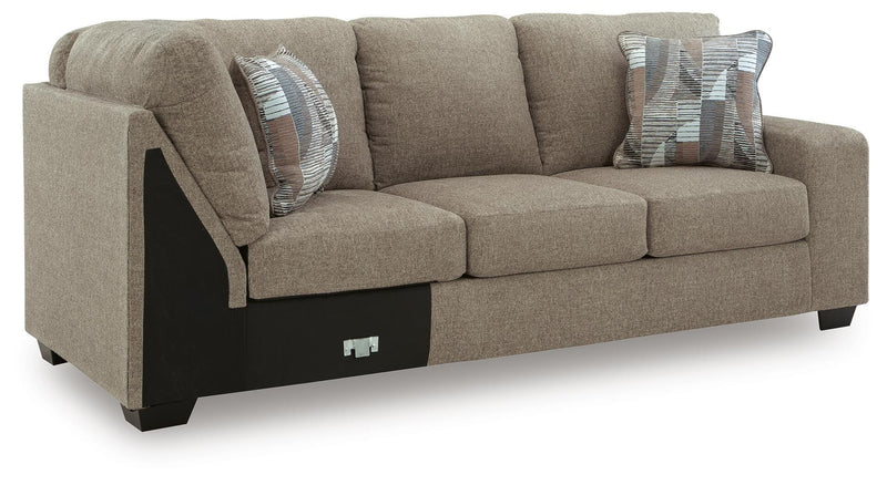 Ashley Furniture Newellen sleeper sectional with chaise, featuring plush cushions and neutral fabric in a modern living room setting.