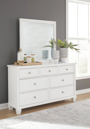 Ashley Furniture Fortman bedroom set with coordinated bed, dresser, mirror, and nightstand furniture.