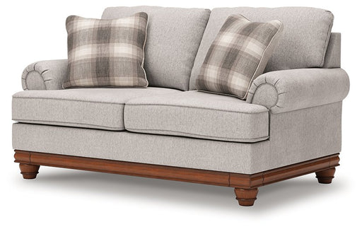 Ashley Furniture Clearbrooke loveseat in beige fabric, angled view showing plush cushions and stylish armrests.