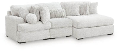 Ashley Furniture Cuddle Plush sectional with chaise, featuring soft fabric upholstery and plush cushions, angled view.