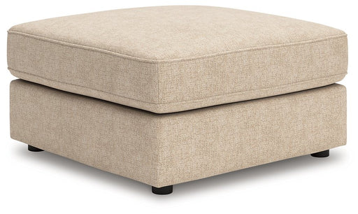 Ashley Furniture Seyler oversized accent ottoman with plush fabric and tufted top, shown from an angled side view.