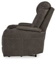 Ashley Furniture Feazada power recliner showing plush fabric, padded armrests, and built-in recline mechanism in a modern living room setting.