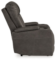 Ashley Furniture Feazada power recliner with plush fabric and padded armrests, shown from the side in a relaxed position.