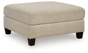 Ashley Furniture Steelwater Retreat oversized accent ottoman with plush fabric and sturdy wooden legs, shown from an angled view.