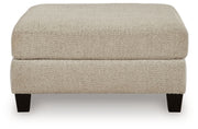 Ashley Furniture Steelwater Retreat oversized accent ottoman with plush fabric and tufted top, shown from a front head-on view.