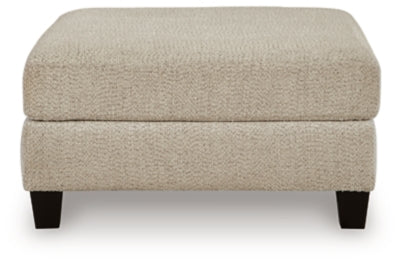 Ashley Furniture Steelwater Retreat oversized accent ottoman with plush fabric and tufted top, shown from a front head-on view.