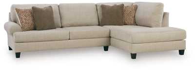 Ashley Furniture Steelwater Retreat sectional with chaise, showing plush gray upholstery and modern design in a living room setting.