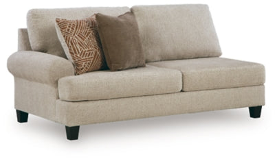 Ashley Furniture Steelwater Retreat sectional with chaise, showing a stylish fabric sofa with multiple cushions in a modern living room setting.