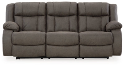 Ashley Furniture First Base reclining sofa with plush cushions and a modern design, shown from a front head-on view.
