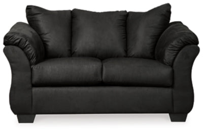Ashley Furniture Darcy Loveseat with plush fabric and cushioned arms, shown in a cozy living room setting.