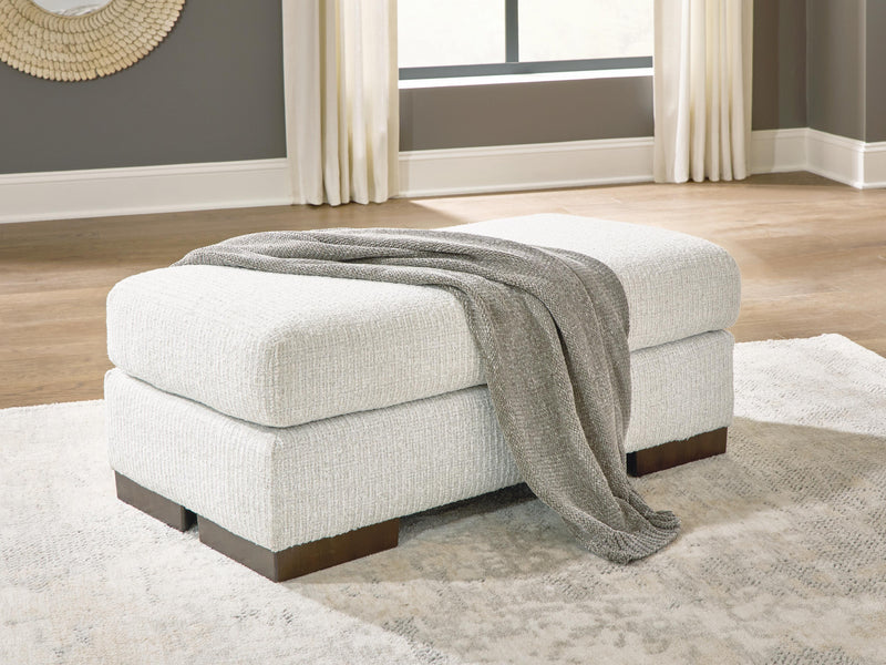 Ashley Furniture Hartside Ottoman with soft fabric upholstery and wooden block legs, shown in a neutral color.