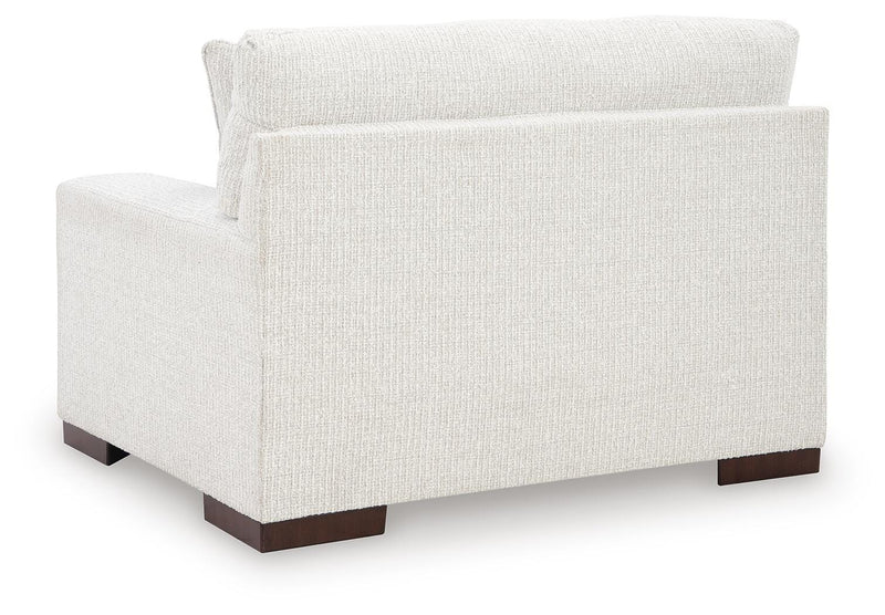 Ashley Furniture Hartside oversized chair with plush fabric and wide armrests, shown from the back in a modern living room setting.