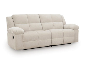 Ashley Furniture Orlen reclining sofa in a stylish fabric, shown from an angled view with closed recliners and plush cushioning.
