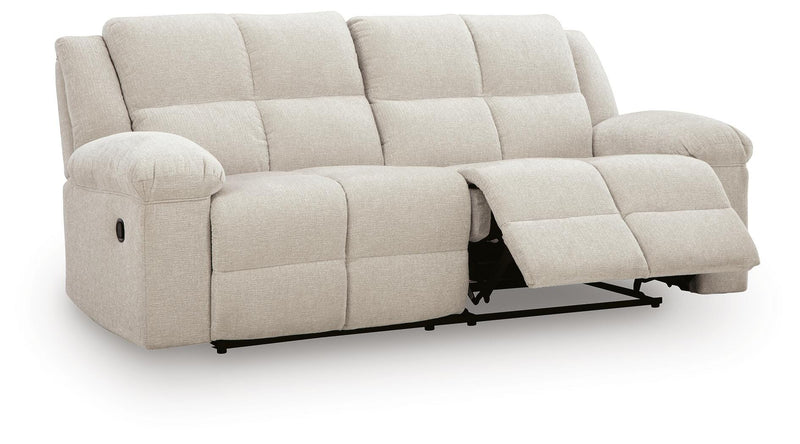Ashley Furniture Orlen reclining sofa, shown from an angle with open recliner, featuring plush cushions and contemporary design.