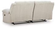 Ashley Furniture Orlen reclining sofa with plush cushions and reclining features, shown from the back view.