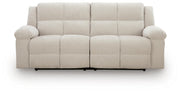 Ashley Furniture Orlen reclining sofa shown from head-on view, featuring plush fabric and padded armrests.