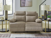 Ashley Furniture side-swipe reclining loveseat with plush fabric and padded armrests, shown in a cozy living room setting.