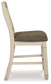 Ashley Furniture Bolanburg counter height bar stool with wooden legs and cushioned seat, ideal for kitchen or bar area.