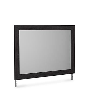 Ashley Furniture Belachime bedroom mirror showing a large, elegant rectangular mirror with a wooden frame in a bedroom setting.