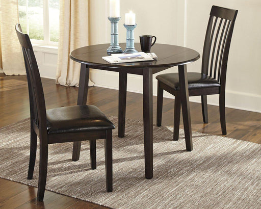 Ashley Furniture Hammis dining set with a wooden table and matching chairs, ideal for a modern dining room.